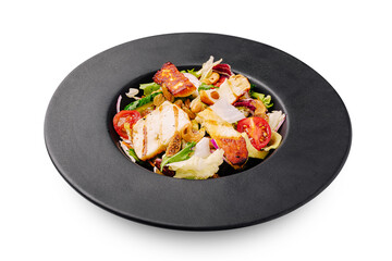 Grilled chicken salad served in a modern black bowl at a dining setting