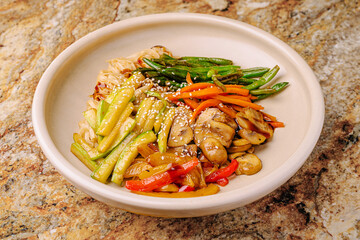 Delicious vegetable stir-fry served in a bowl on a colorful countertop