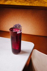Refreshing drink served in a tall glass with flowers on the rim