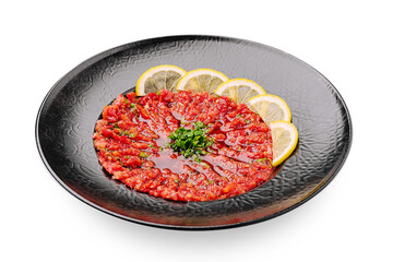 Homemade vegetable winter appetizer made from roasted peppers, tomatoes, and eggplants, drizzled with olive oil and garnished with parsley and lemon slices