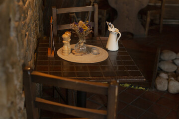 Rustic dinner setting, Charming restaurant tableau showcasing rustic furnishings and soft illumination