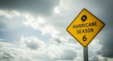 Hurricane season warning sign against cloudy sky