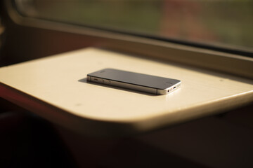 Compact phone work area during commute, Portable device environment with scenic window view and calm