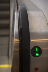 Green indicator detail, Contemporary transportation hub showcases illuminated handrail and reflective surfaces