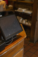 Preopening scene with steaming cups and aged wood, Calm cafe setting with dusty touch screen and cozy lighting