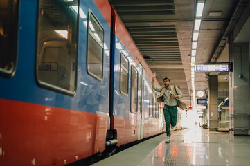 Man chasing departing train at subway station
