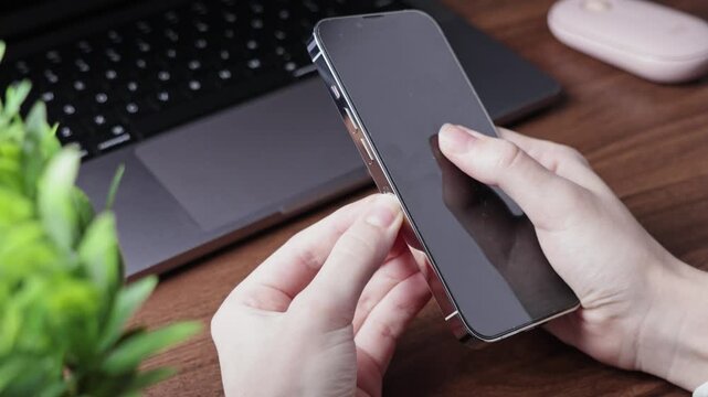 Person's hands meticulously inserting a nano SIM card into the dedicated side slot of a modern smartphone for essential network connectivity and activation
