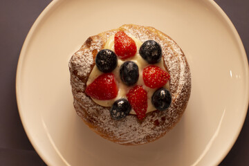 Sweet Italian pastry served on a plate, showing baked food presentation. Mediterranean cuisine and tradition of Italian bakery culture.