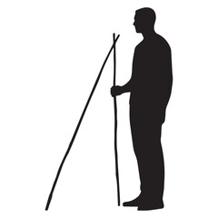 Obraz premium Silhouette of a man standing confidently holding a long straight stick horizontally. 