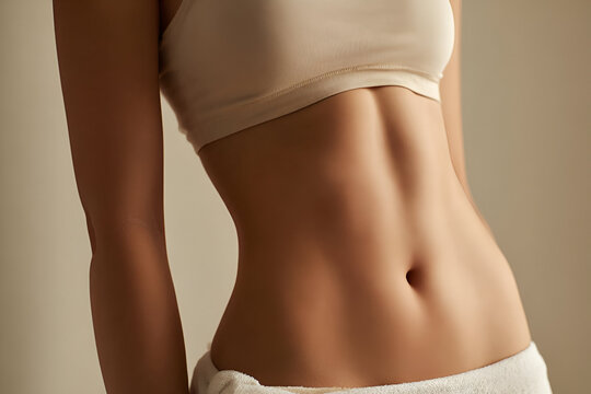 A close-up view of a fit female torso showcasing toned abs and smooth skin, highlighting health and wellness.