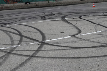Traces of car wheels on the asphalt. © indigolotos