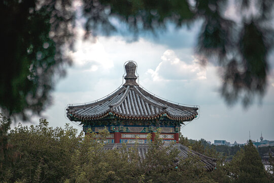 Beijing's Summer Palace in China, an ancient building. Close up on architectural details. The focus is on the intricate design against a cloudy sky.