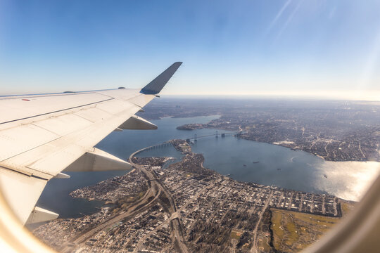 Beautiful view looking out an airplane window - Travel image with a bridge going over a river
