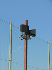 Obraz premium Speakers for broadcasting are mounted on the steel pole in the public sports park.