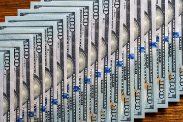 Background of many american one hundred dollar banknotes. A pile of new one hundred US dollars. Cash of hundred dollar bills, closeup
