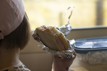 Child enjoys lunch, Child eagerly waiting to take first bite, Casual scene of child preparing to eat lunch
