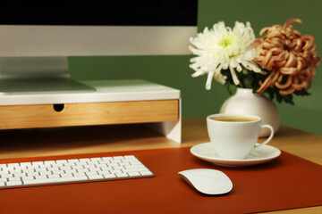 Stylish workplace with computer and brown mat on desk in office, closeup