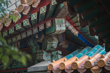 Close-up view of ancient building details at the Summer Palace in Beijing, China. Ornate architecture showcases traditional Chinese design. Captured under natural sunlight.