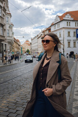 Stylish Woman on Cobblestone Street in European City.