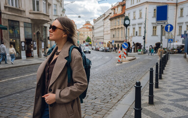 Stylish Woman on Cobblestone Street in European City.