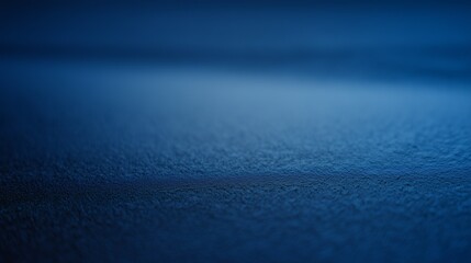 Dark blue frosty background with smooth icy texture and soft gradient lighting. Ideal for winter banners, minimal designs, product presentations, or seasonal marketing visuals.