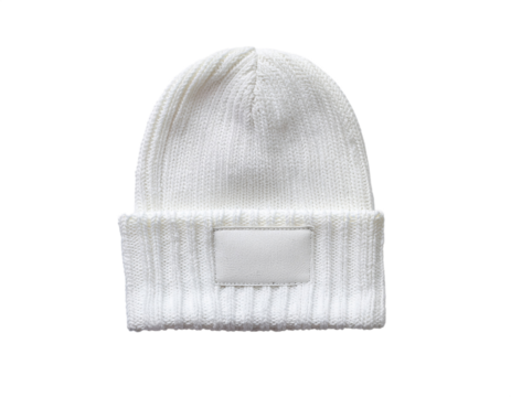 Classic white knitted beanie hat with folded brim and blank label for personalization isolated on transparent background