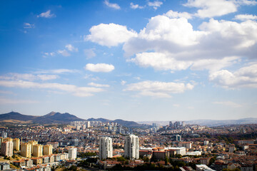 Mountains and city view under cloudy sky