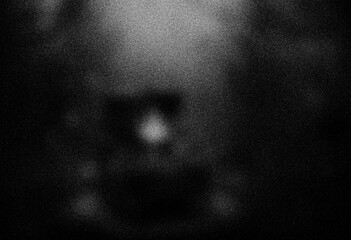 Abstract dark background with glowing center and bokeh effect