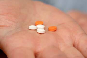 Colorful pills resting in an open hand during a health check
