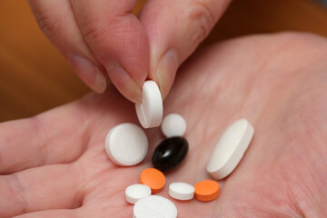 Display of various pills in a hand during a health check-up