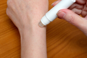 Applying a soothing roll-on treatment for skin relief