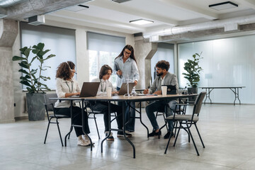 Company staff is sitting. Group of people are working in the office together as a team