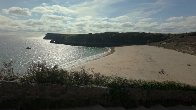 Summertime establishing shot of Barafundle Bay Beach on the Pembrokeshire coast, Wales.