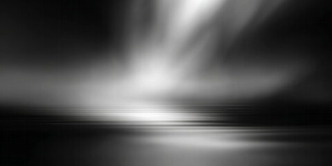 Fototapeta premium Dramatic black and white spotlight illuminates a reflective, horizontal surface