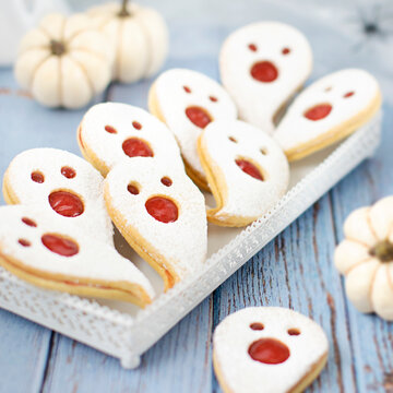 Ghost-shaped shortbread cookies with strawberry jam &ndash; Halloween treats