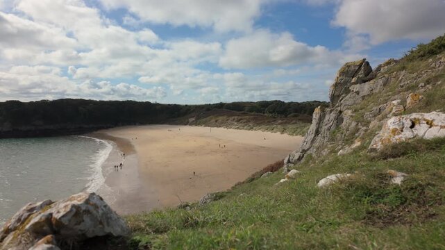 Summertime establishing shot of Barafundle Bay Beach on the Pembrokeshire coast, Wales.