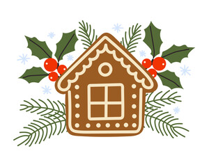 Gingerbread house decorated with holly and evergreen branches for festive winter celebration