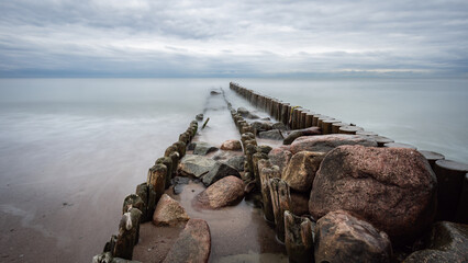 boulders and wooden breakwaters on the beach