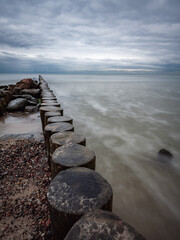 boulders and wooden breakwaters on the beach