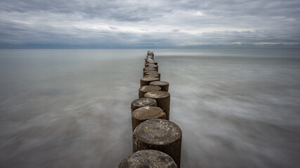 boulders and wooden breakwaters on the beach