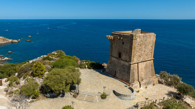 Aerial view of a medieval tower overlooking the Mediterranean Sea. It is located in the Zingaro Nature Reserve in Scopello, in the province of Trapani, Sicily, Italy.