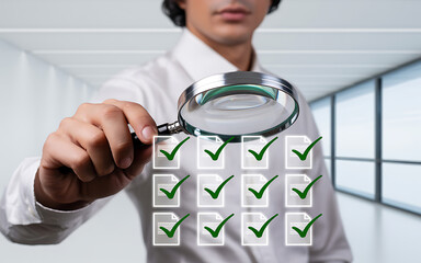 Man with magnifying glass checking off items on a list