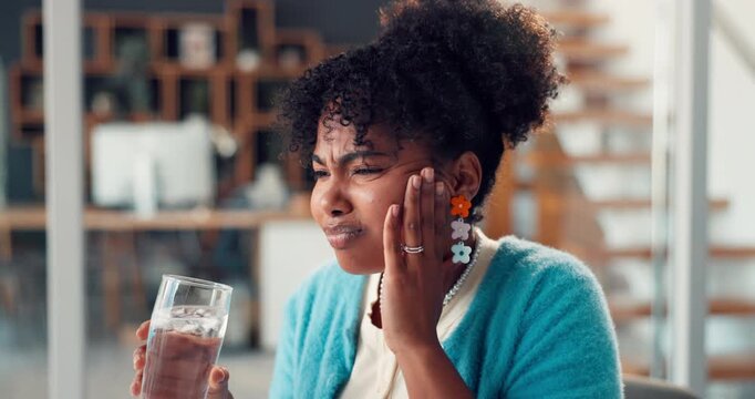 Woman, drinking water and toothache in office at startup with stress, cavity or sore with gum disease. Person, writer and pain with sensitive teeth, massage and glass with project at creative agency