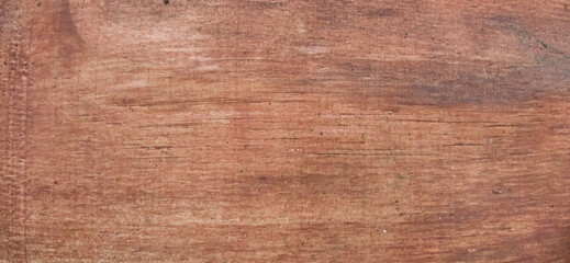 Close-up horizontal grain texture of reddish brown wood plywood
