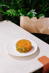 Delicious dessert on a stylish table surrounded by greenery in a modern setting