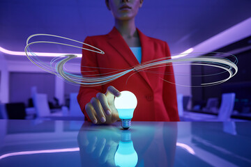 Woman in red jacket holding a glowing light bulb with abstract energy