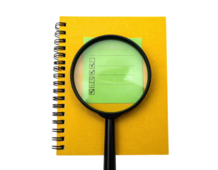 A magnifying glass focuses on a checklist notepad, emphasizing the marked items and vibrant colors.