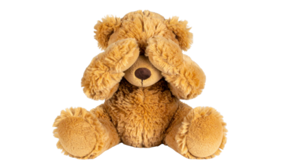 A fluffy teddy bear covering its eyes, embodying innocence and playfulness.