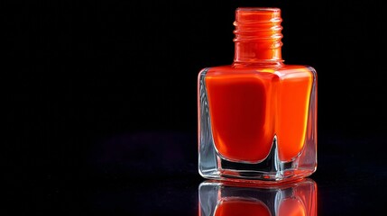 Vibrant red nail polish bottle against a black background for beauty and cosmetics theme