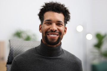 Portrait of handsome man at workplace in office